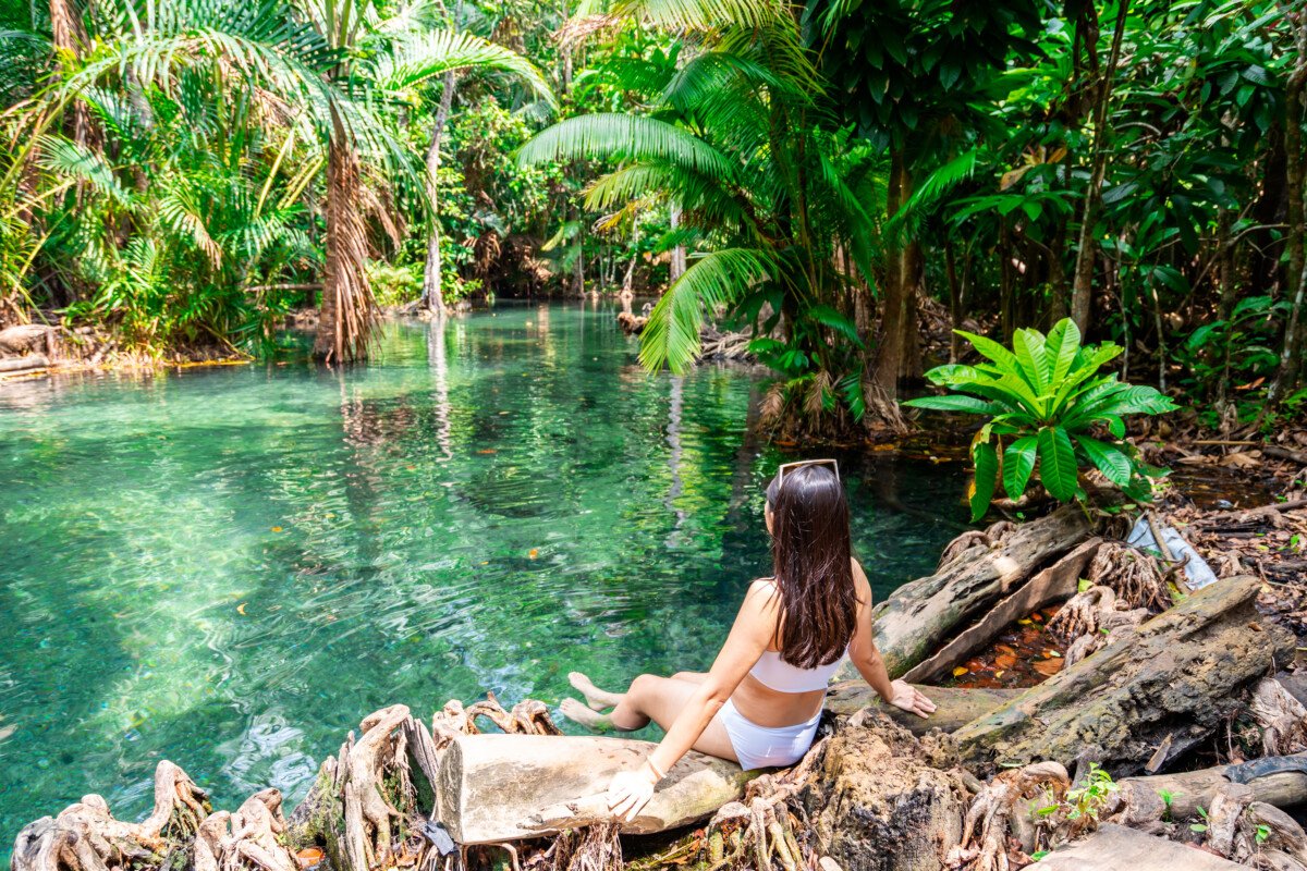 Young woman tourist relaxing and enjoying at klong nam sai in Krabi, Thailand